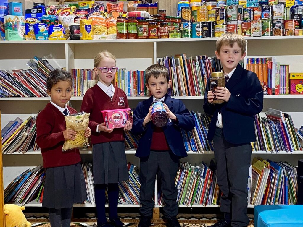 Students holding up goods for families