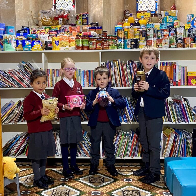 Students holding up goods for families