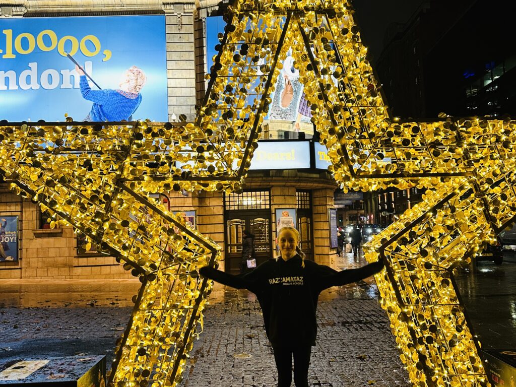 Student stood behind a star display