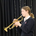 student playing an instrument