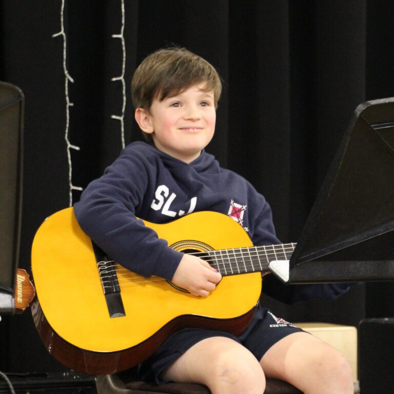 boy playing the guitar