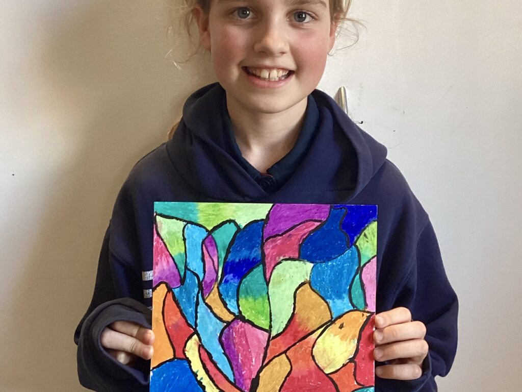 emilia holding a colourful drawing
