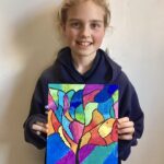 emilia holding a colourful drawing