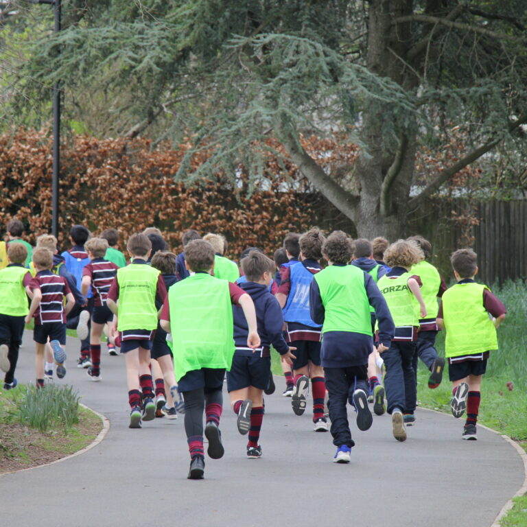 group of boys running across the pavement