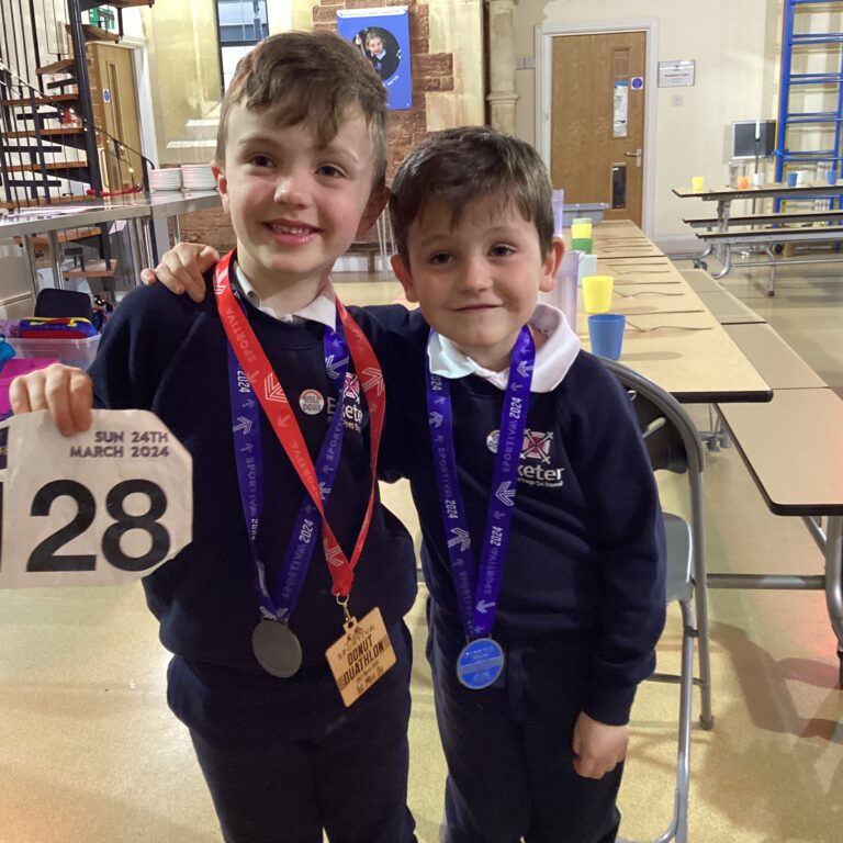 Students wearing medals from their runs