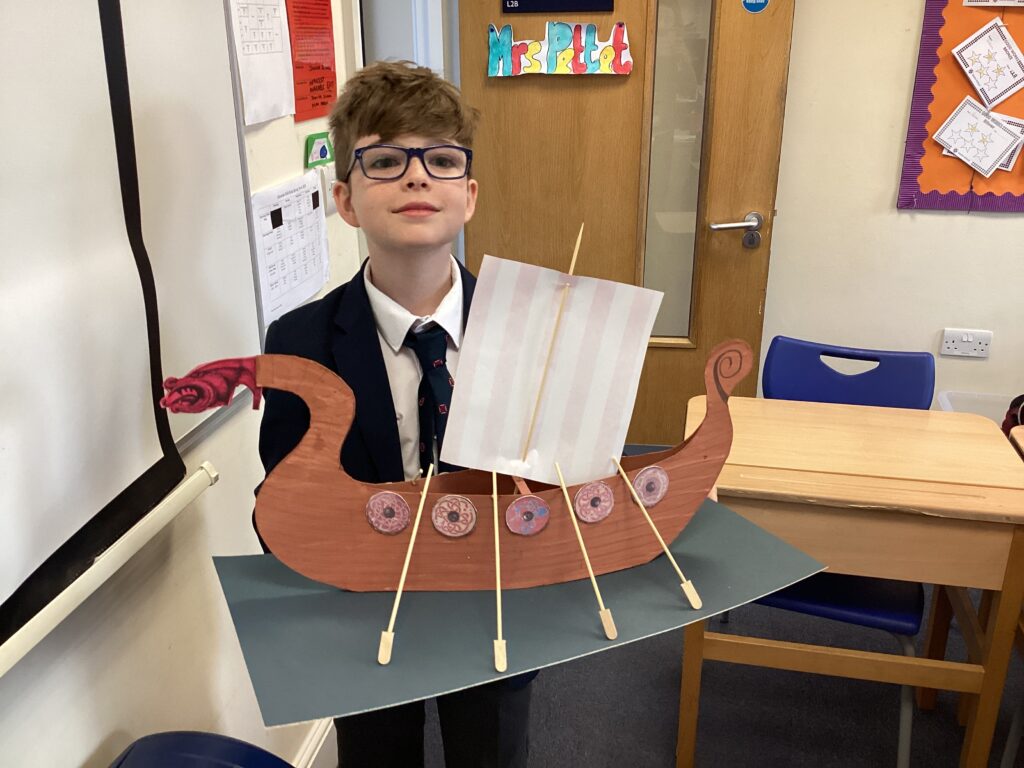 student showing his viking boat