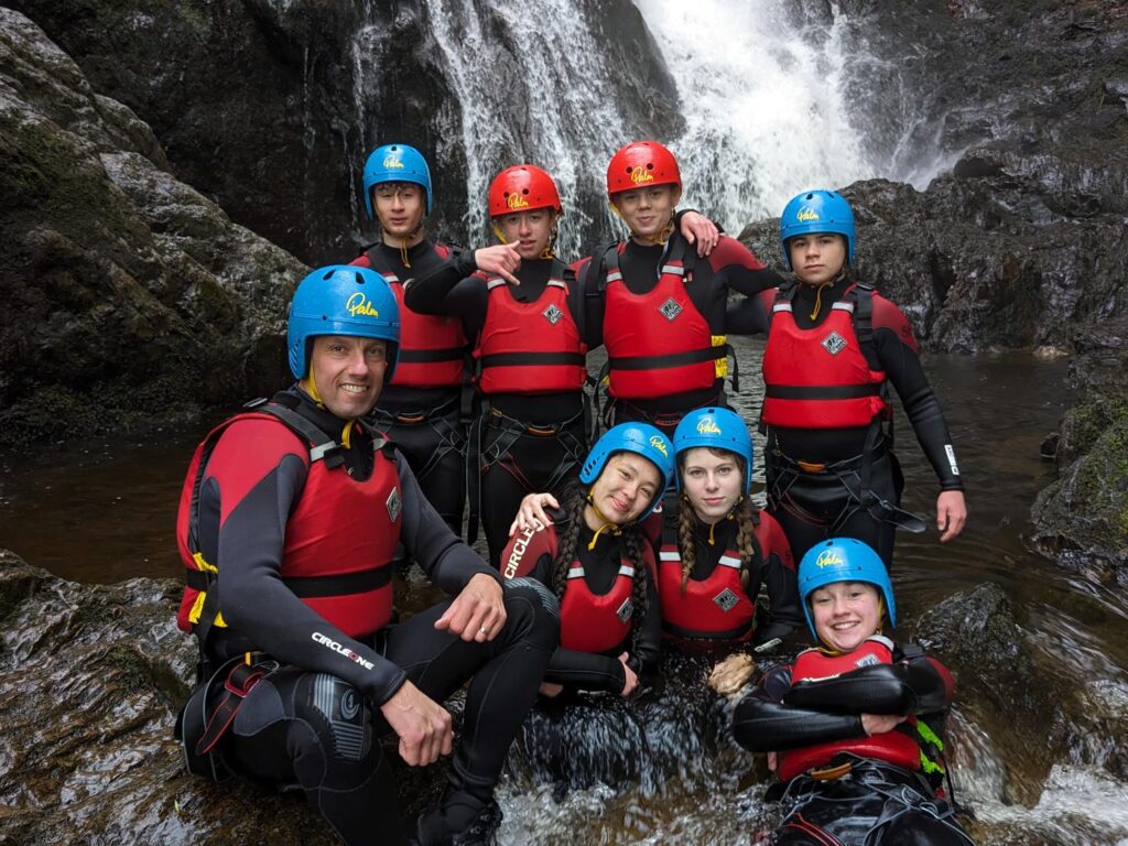 students under a waterfall