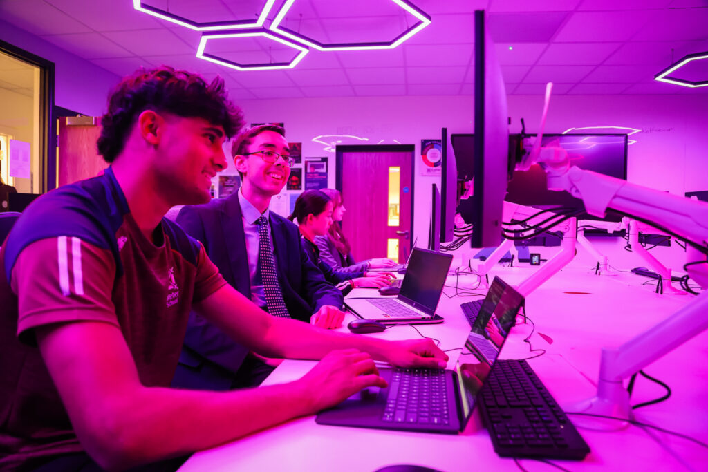 students in a pink lit room