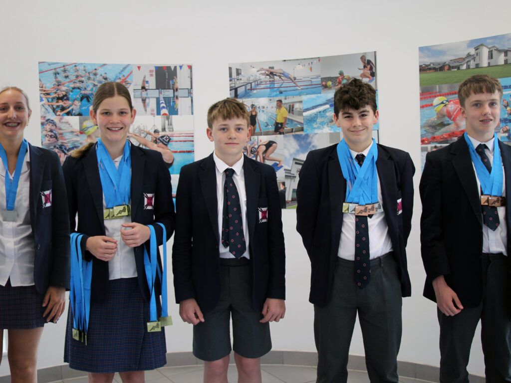 students holding medals