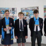 students holding medals