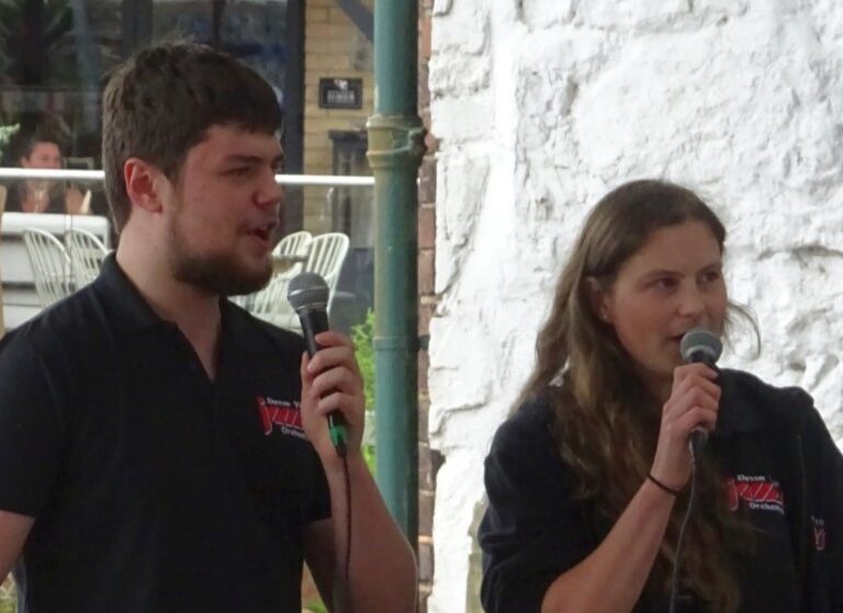 two people speaking into microphones