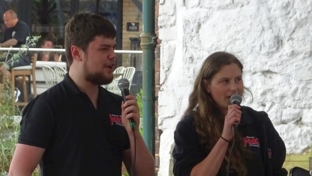 two people speaking into microphones