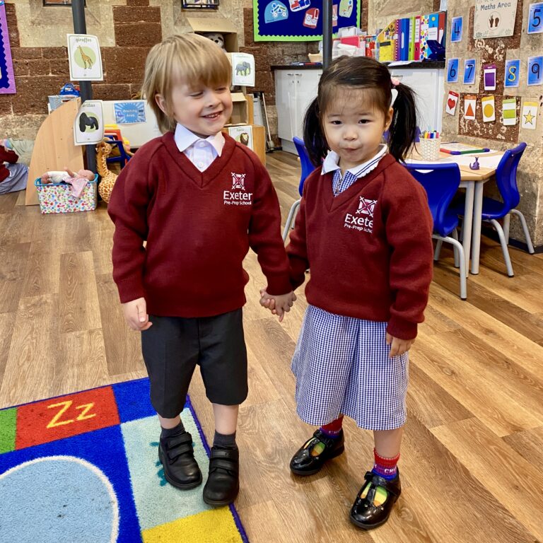two pre-prep children holding hands