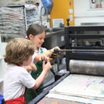 students using an art press