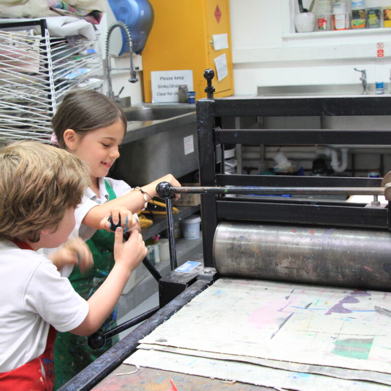 students using an art press