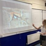 lower sixth form biology student presenting a research presentation in class