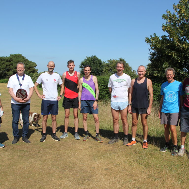 A group of runners in a field on a sunny day