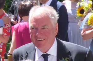 Man in suit in a crowd on sunny day