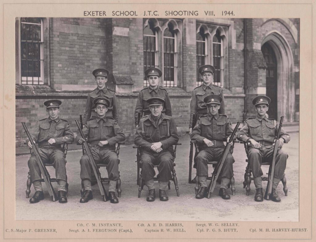 Black and white photo from 1944 of servicemen in uniform in front of building