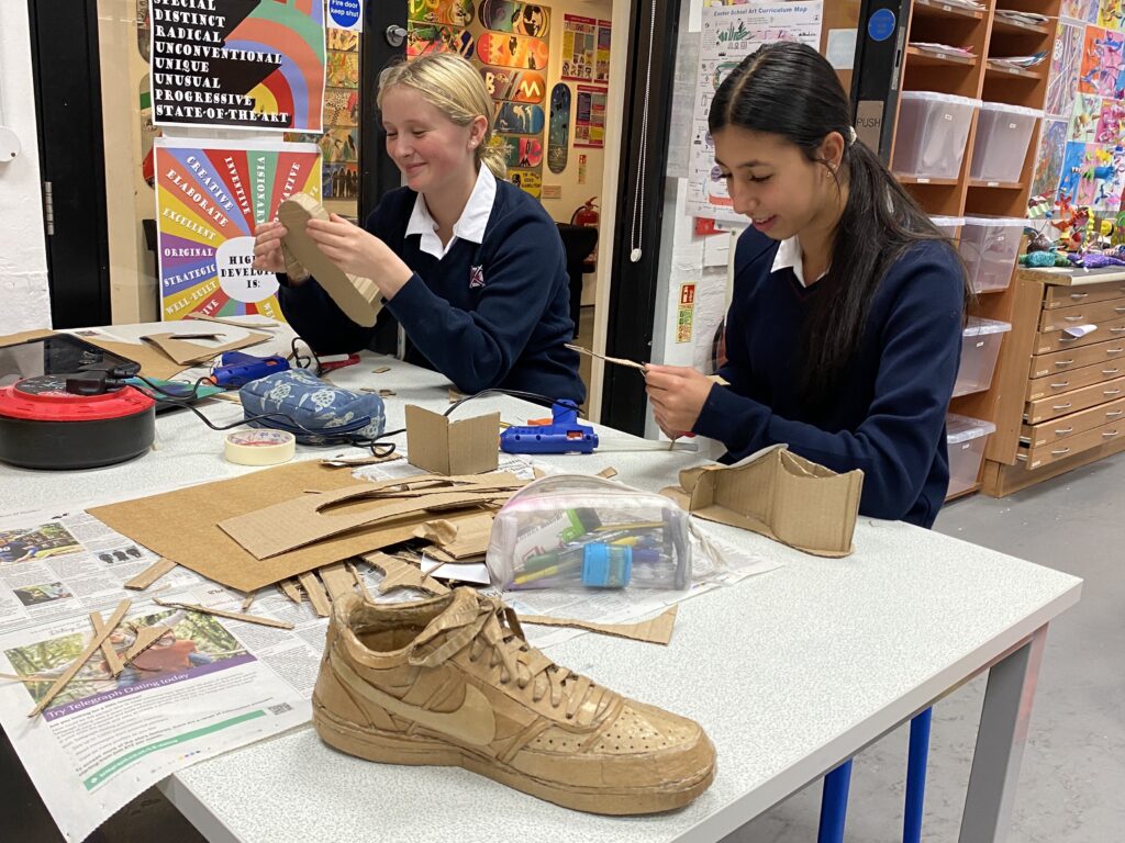 Pupils creating cardboard shoes