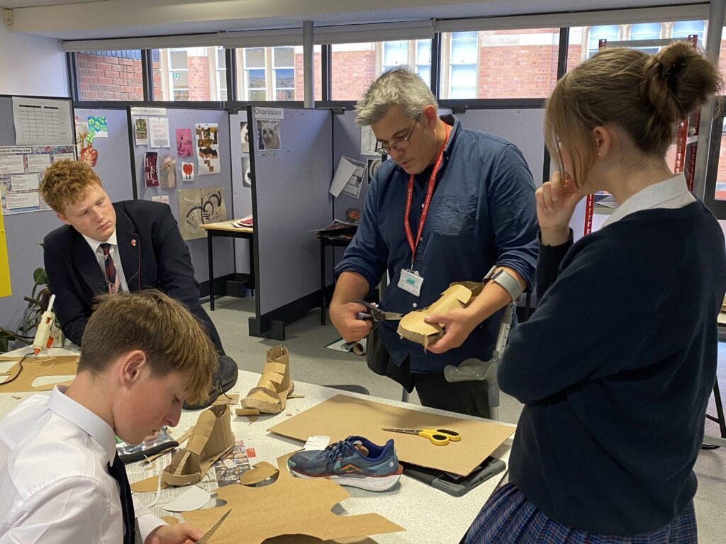 James Lake talking to pupils about cardboard sculpture