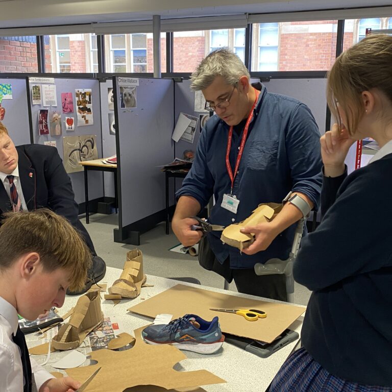 James Lake talking to pupils about cardboard sculpture