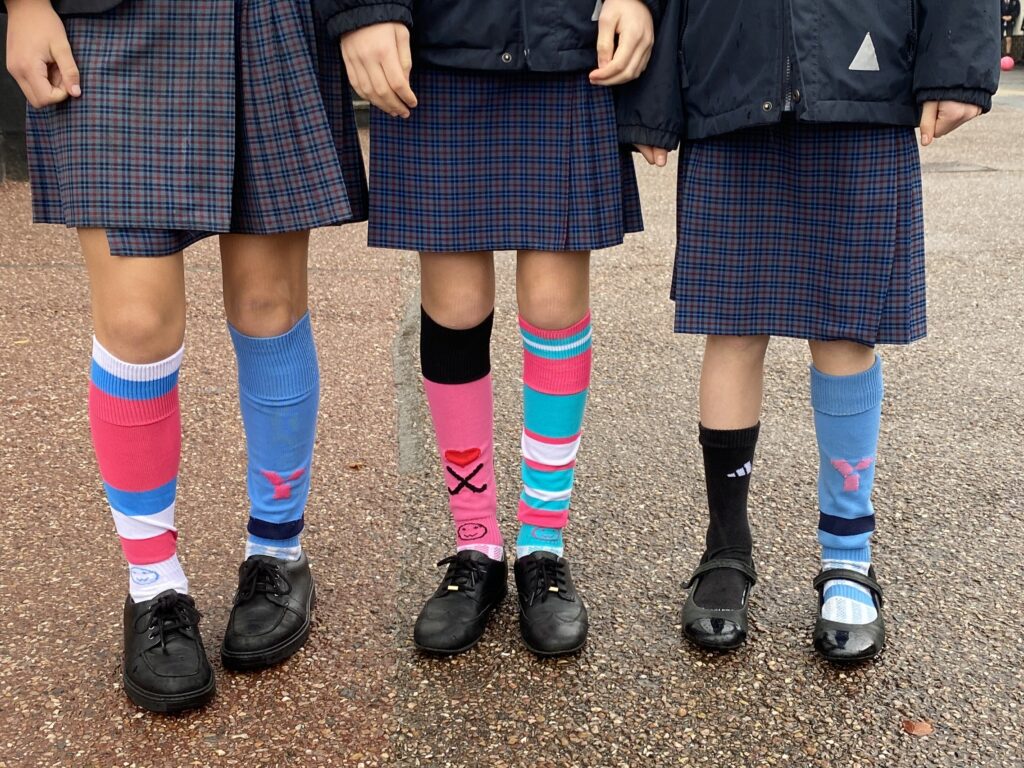 Three pupils wearing odd socks