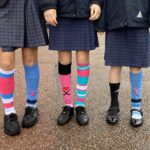 Three pupils wearing odd socks