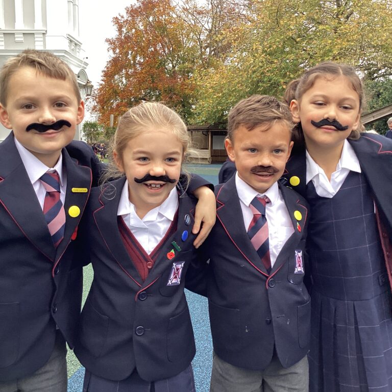 Group of pupils wearing fake moustaches for Movember