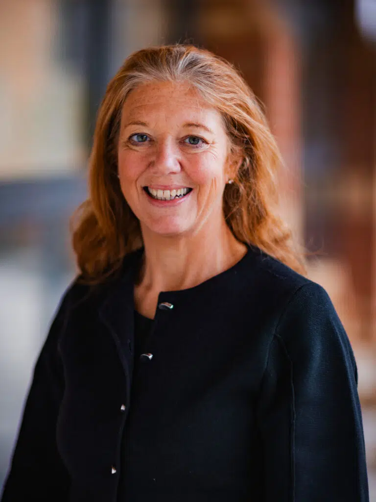 Head shot of smiling lady in black jacket outside
