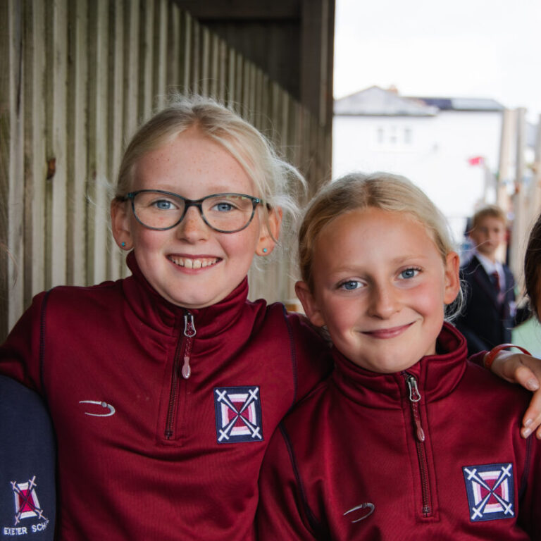 four girls stood in a line smiling